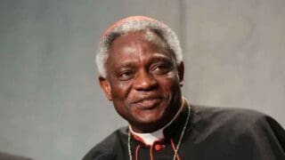 Issu d'une famille modeste, cet homme de 76 ans a été le premier religieux d'Afrique de l'Ouest à être créé cardinal, une décision prise en 2003 par Jean Paul II. Il est actuellement le chancelier de deux académies pontificales, celles des Sciences et des Sciences sociales.